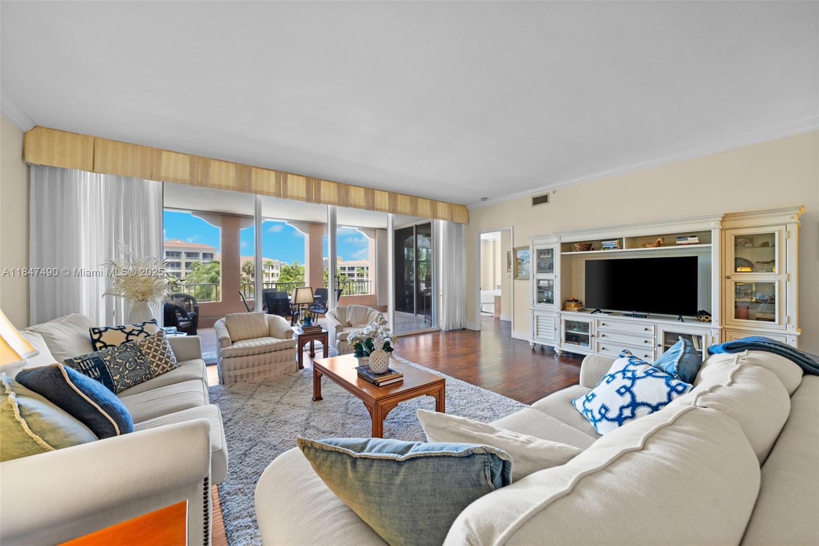 733 Crandon Boulevard, Unit 405 Key Biscayne, FL 33149 - Photo 6 of 42 a living room with furniture and a flat screen tv