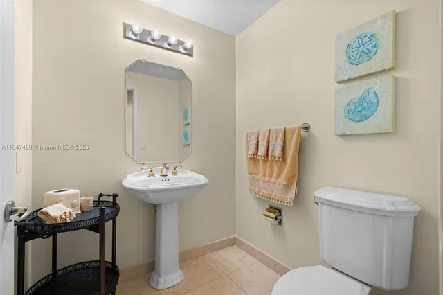 a bathroom with a sink mirror and toilet