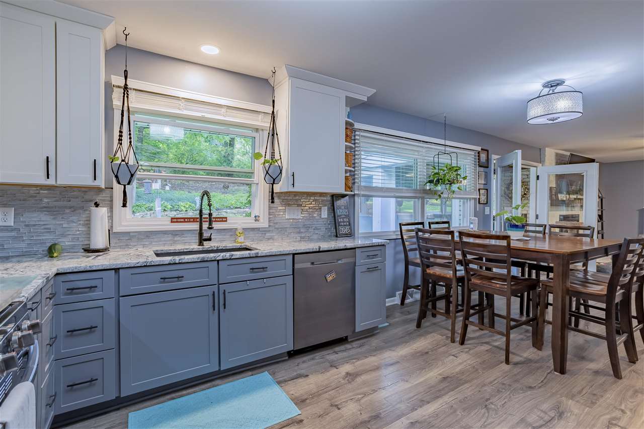 3208 Spring Creek Road Rockford, IL 61107 - Photo 12 of 45 a kitchen with a table chairs sink and cabinets