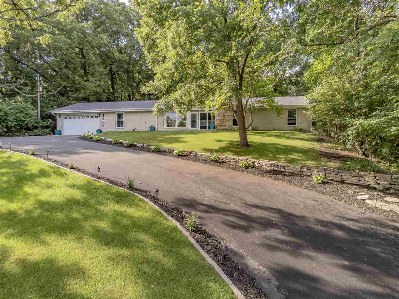 3208 Spring Creek Road Rockford, IL 61107 - Photo 3 of 45 a view of a house with a yard and large trees
