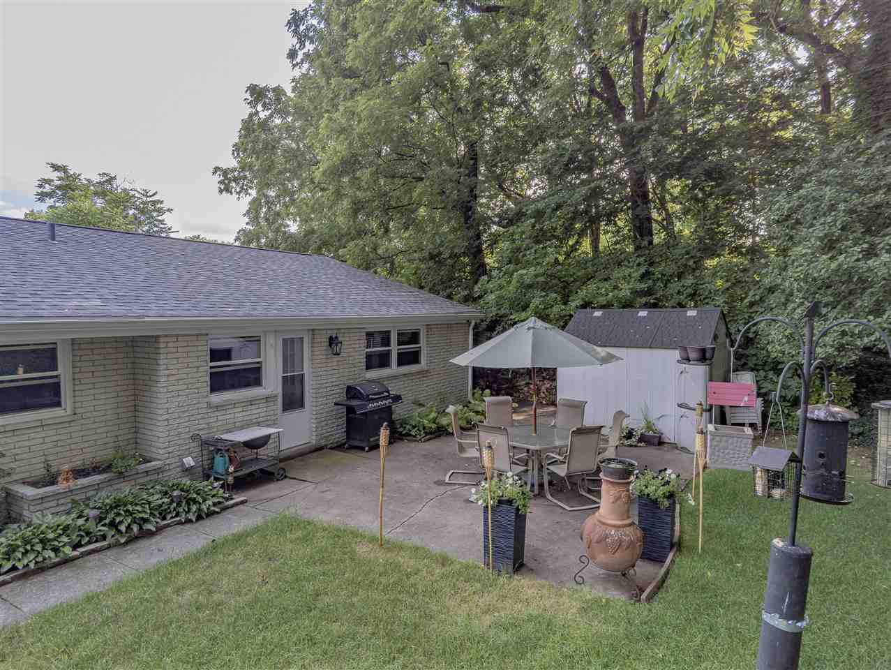 3208 Spring Creek Road Rockford, IL 61107 - Photo 36 of 45 a front view of a house with a garden and sitting area