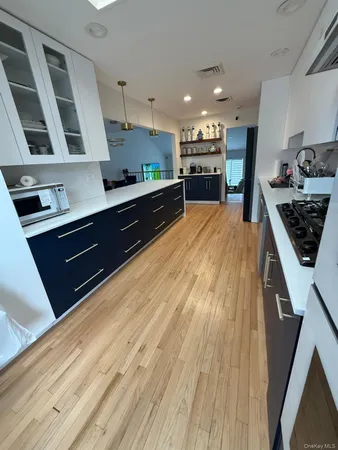 a open kitchen with stainless steel appliances granite countertop a refrigerator and a stove top oven