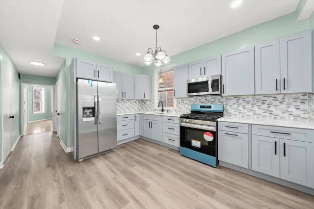 a kitchen with stainless steel appliances white cabinets and a stove