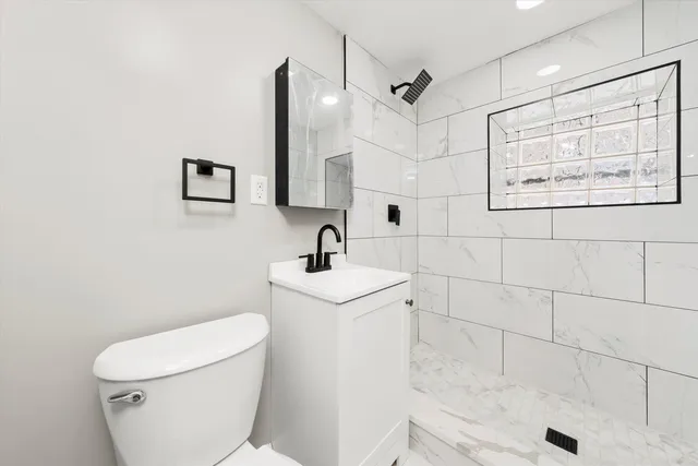 a bathroom with a sink a toilet and mirror