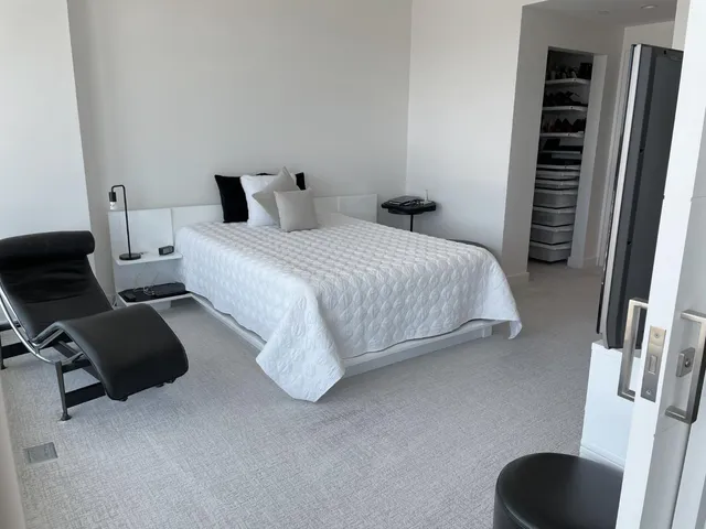 a bedroom with a bed and a chair