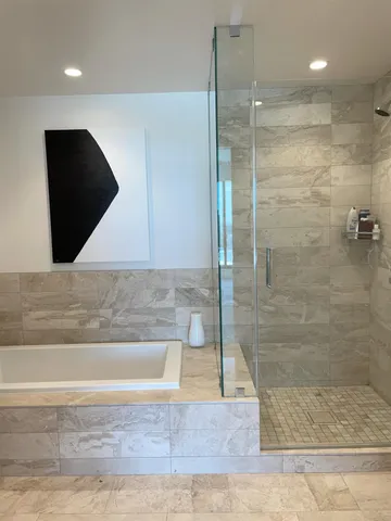 a bathroom with a bathtub and a shower
