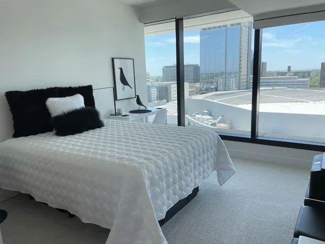 a bedroom with a large bed and a large window