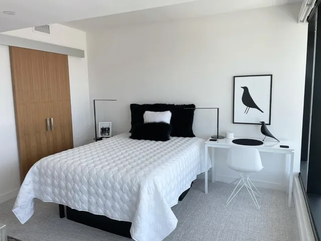 a bedroom with a bed and window