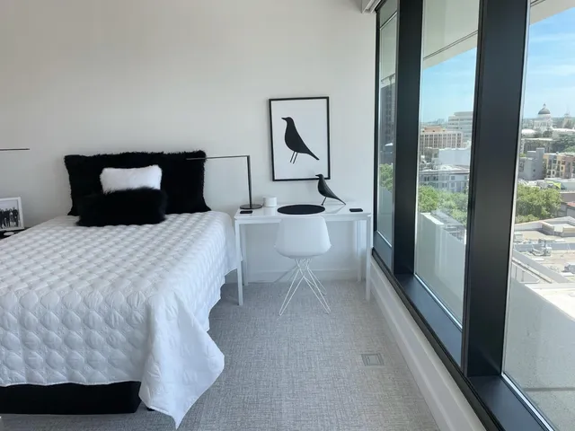 a bedroom with a bed and a large window
