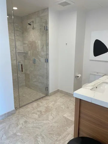 a bathroom with a sink a mirror and shower