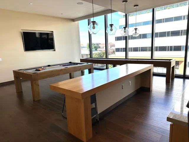 a kitchen with stainless steel appliances granite countertop a sink a stove and a wooden floor