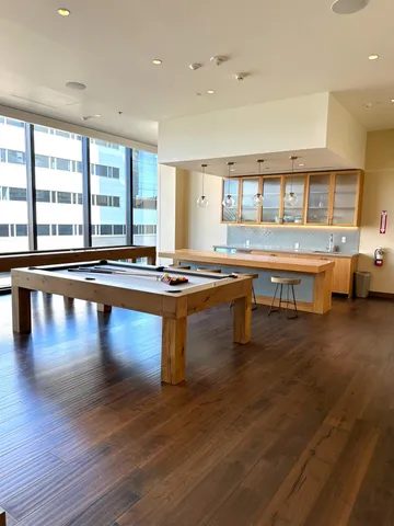 a room with lots of wooden furniture and large windows