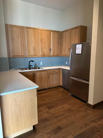 a kitchen with stainless steel appliances a refrigerator sink and cabinets