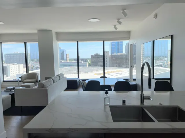 a living room with furniture and large windows