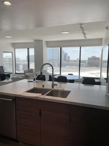a kitchen with a sink and a large window