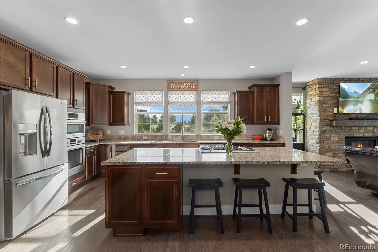 5181 Appleton Way Castle Rock, CO 80104 - Photo 11 of 44 a kitchen with stainless steel appliances granite countertop a sink and a refrigerator