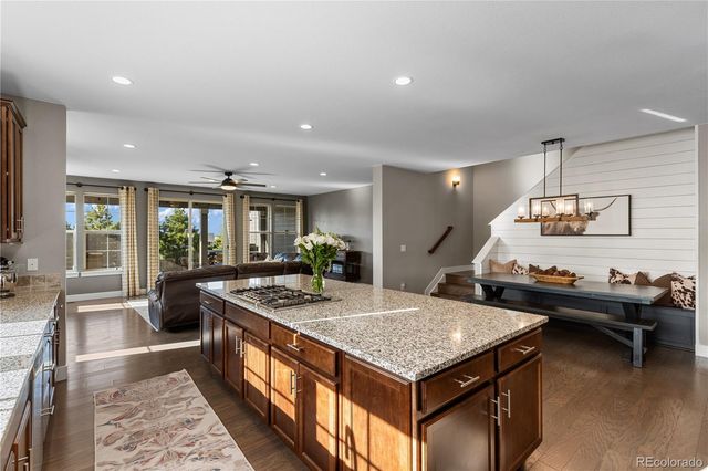 a kitchen with sink stove and refrigerator
