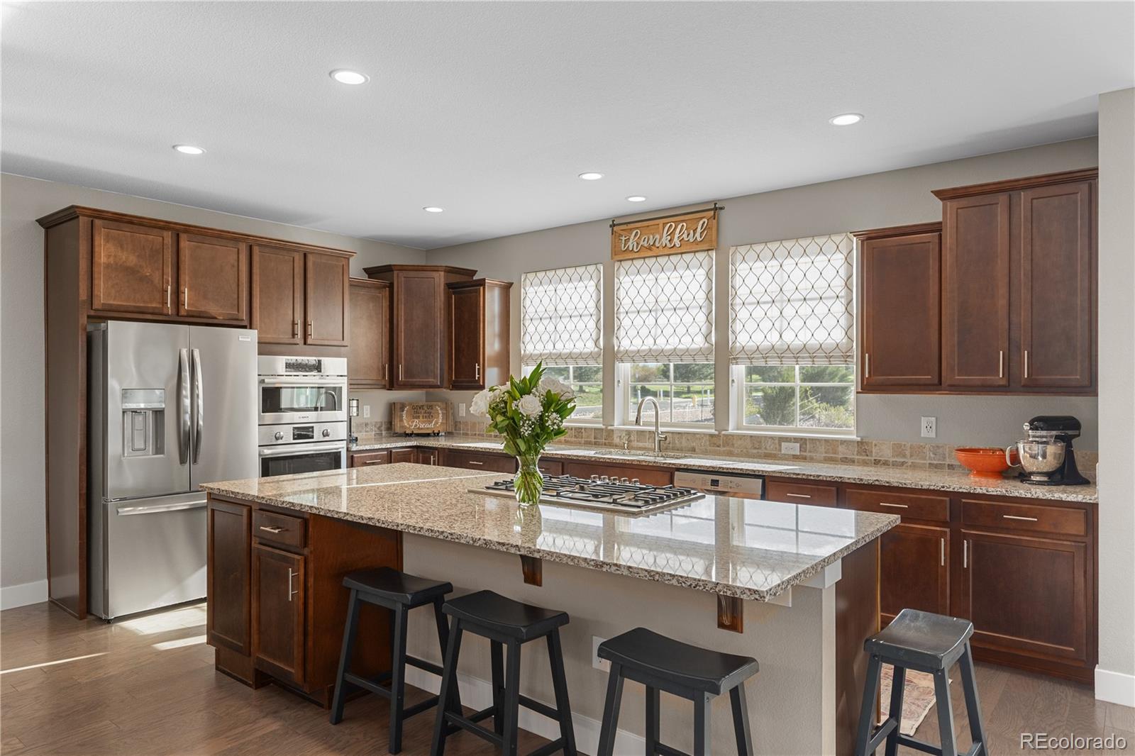 5181 Appleton Way Castle Rock, CO 80104 - Photo 13 of 44 a kitchen with granite countertop a sink and refrigerator