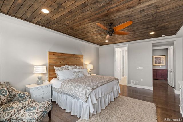 a bedroom with a bed and a ceiling fan