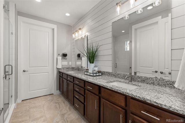 a bathroom with double sink and a mirror
