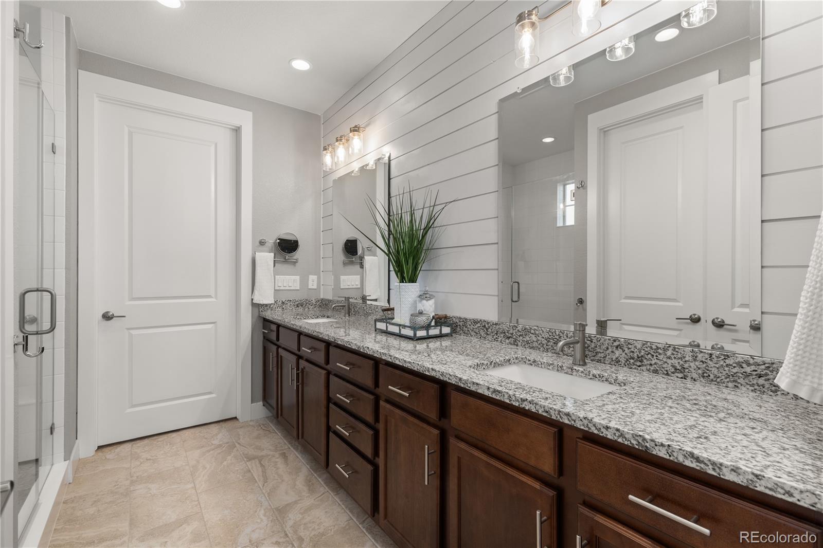 5181 Appleton Way Castle Rock, CO 80104 - Photo 19 of 44 a bathroom with double sink and a mirror