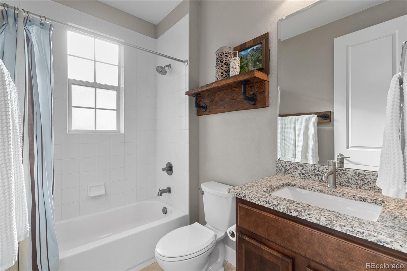 5181 Appleton Way Castle Rock, CO 80104 - Photo 24 of 44 a bathroom with a granite countertop sink toilet and shower