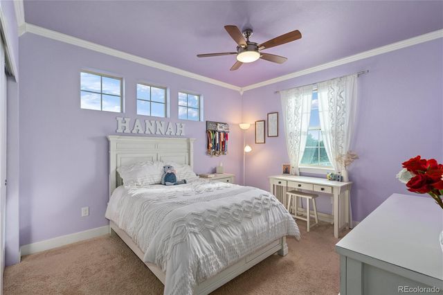 a bedroom with a bed chandelier and a window