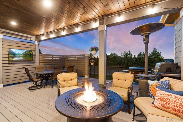 a dining room with furniture a fireplace and wooden floor