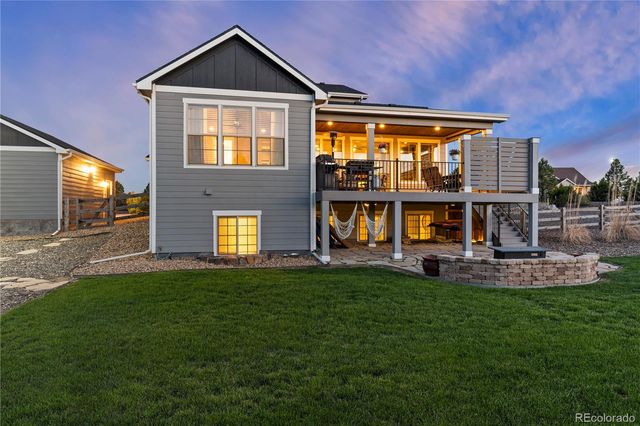 a view of a house with a yard and sitting area