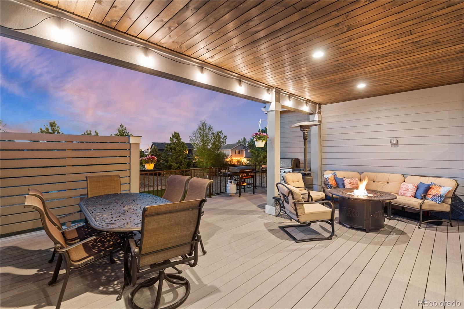 5181 Appleton Way Castle Rock, CO 80104 - Photo 5 of 44 a view of a patio with dining table and chairs with wooden floor and fence