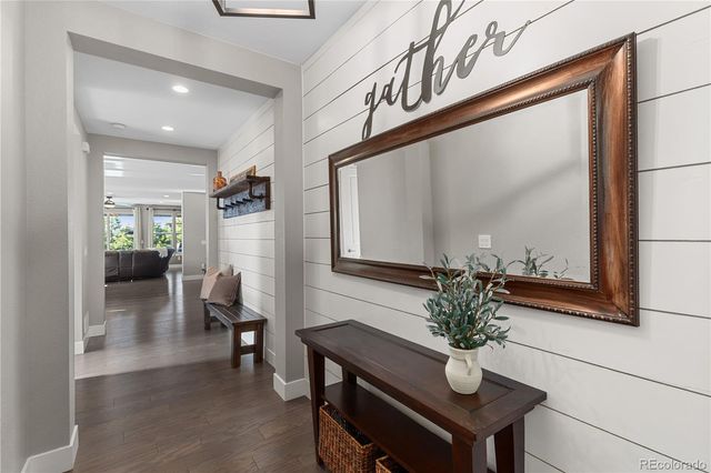 a view of a hallway with furniture and a potted plant