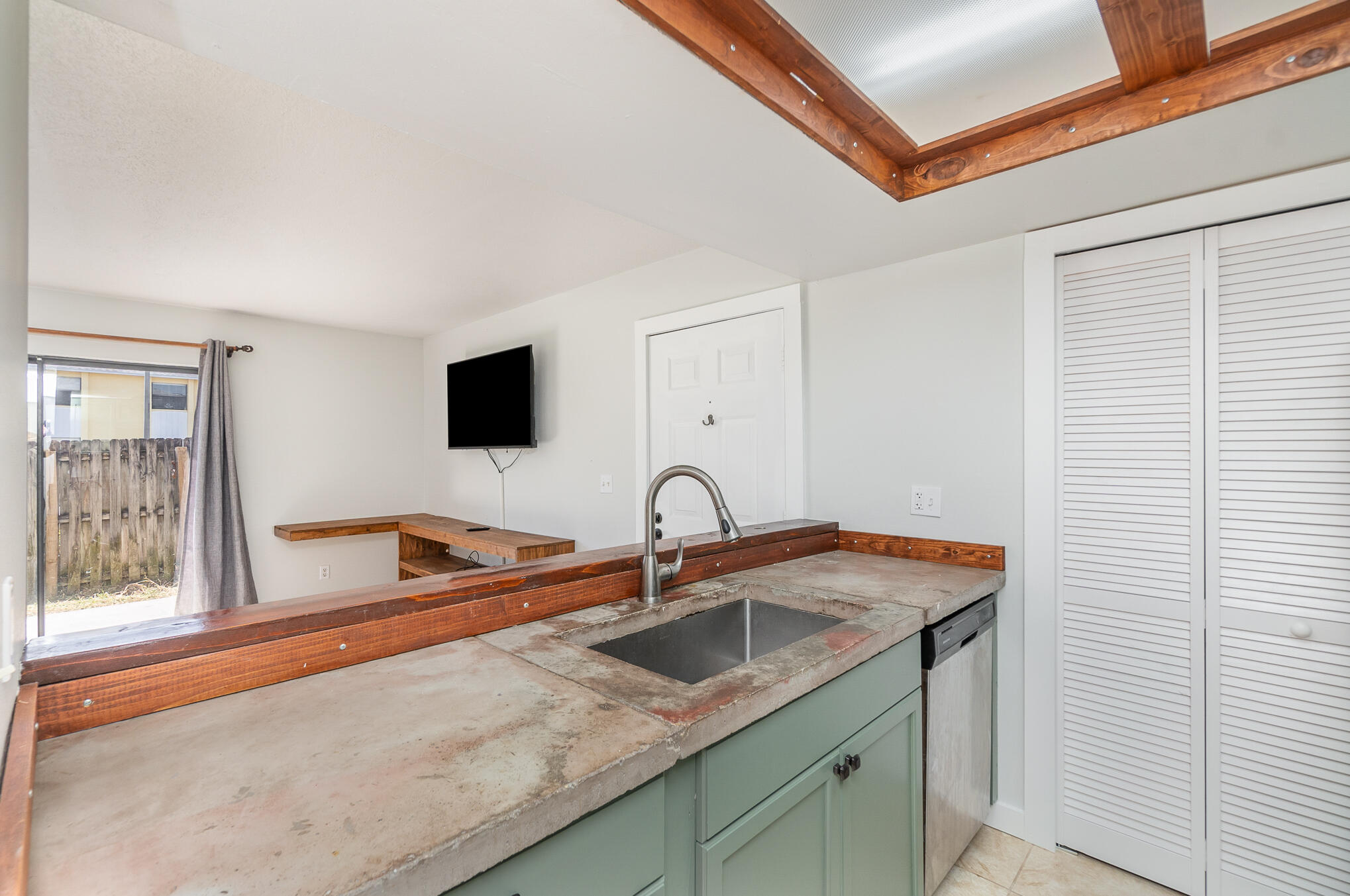598 North Wickham Road, Unit 75 Melbourne, FL 32935 - Photo 10 of 21 a kitchen with stainless steel appliances granite countertop a sink and a window