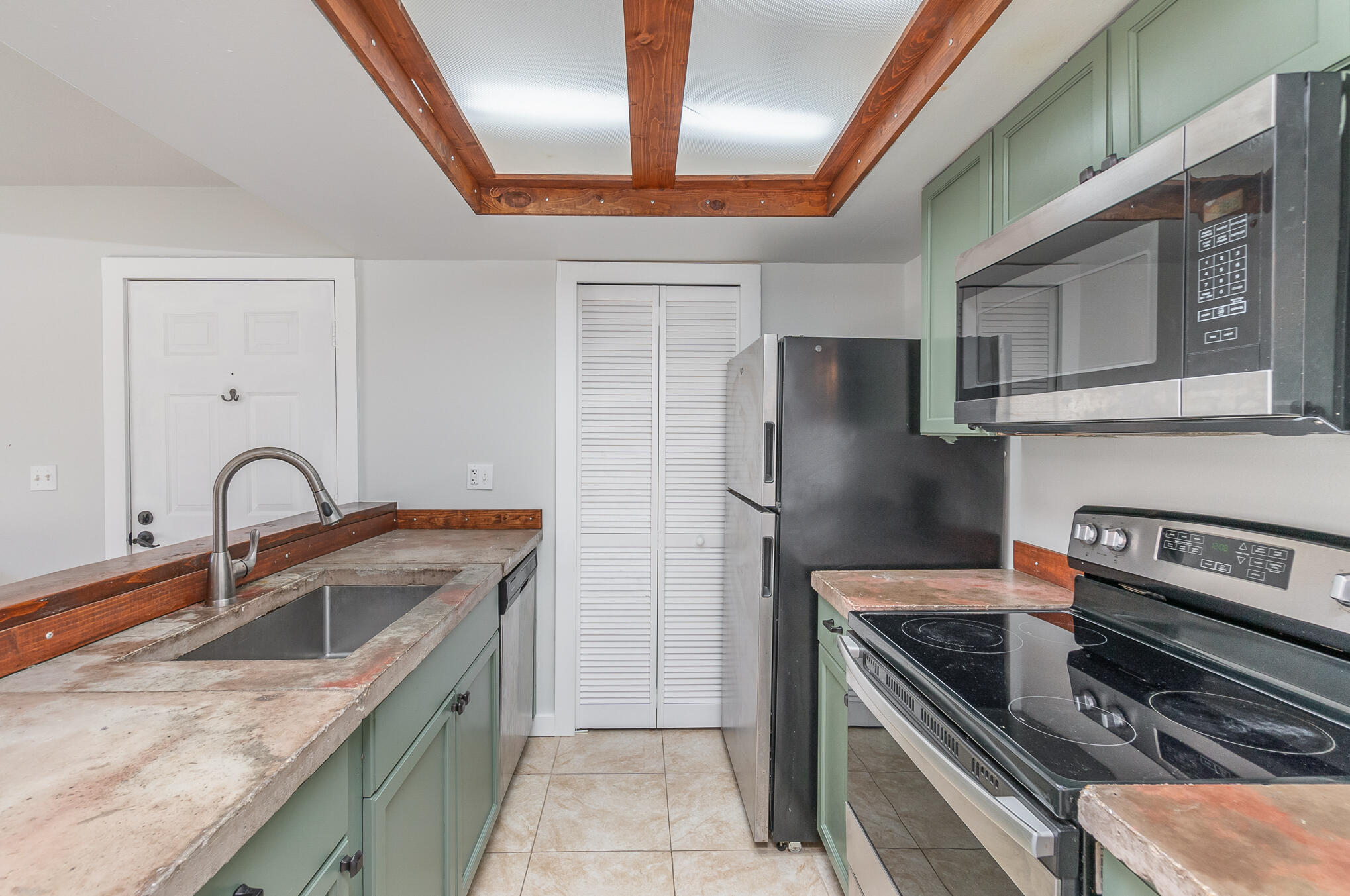 598 North Wickham Road, Unit 75 Melbourne, FL 32935 - Photo 11 of 21 a kitchen with stainless steel appliances granite countertop a sink stove and refrigerator