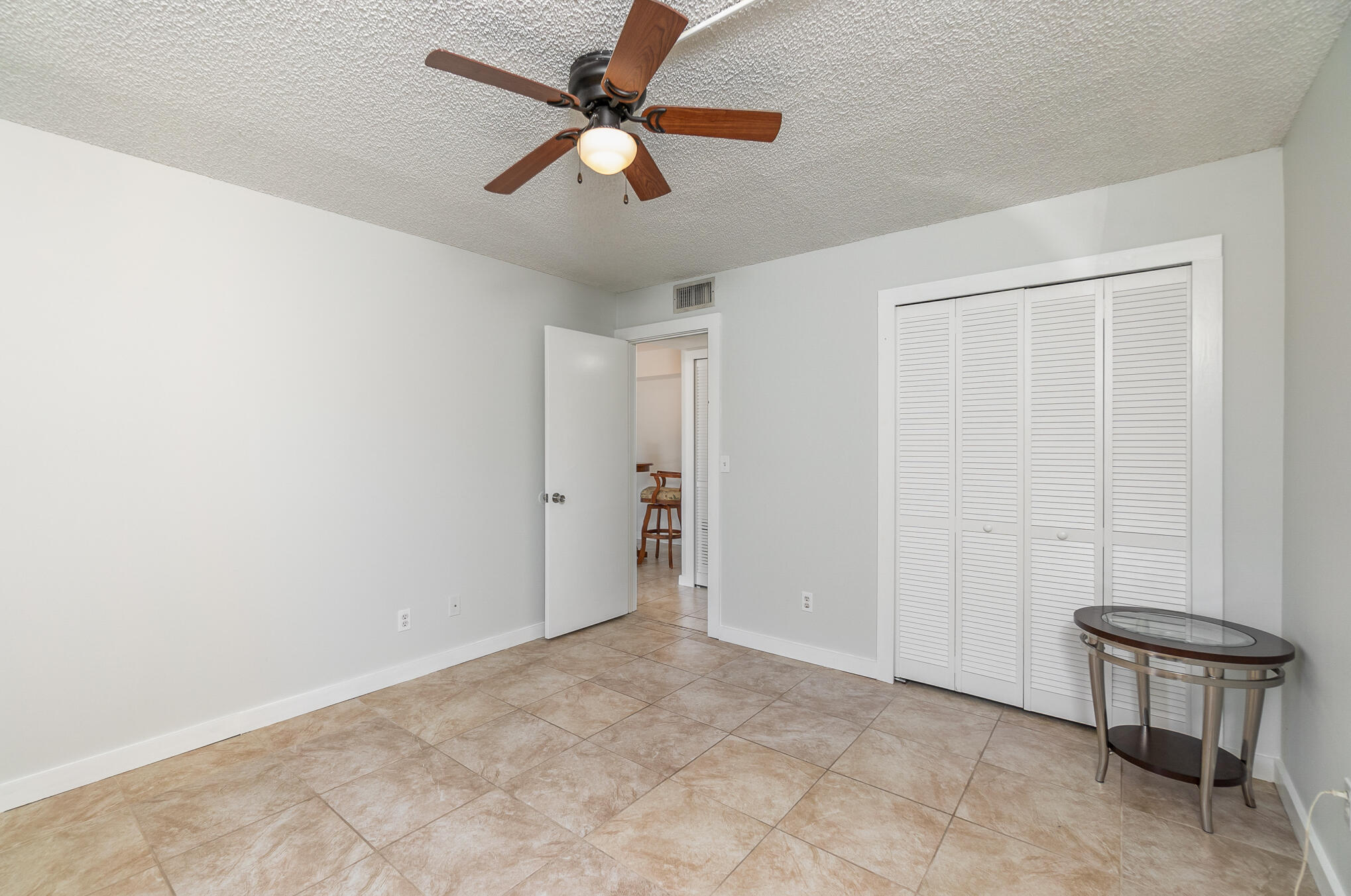 598 North Wickham Road, Unit 75 Melbourne, FL 32935 - Photo 15 of 21 an empty room with windows and ceiling fan