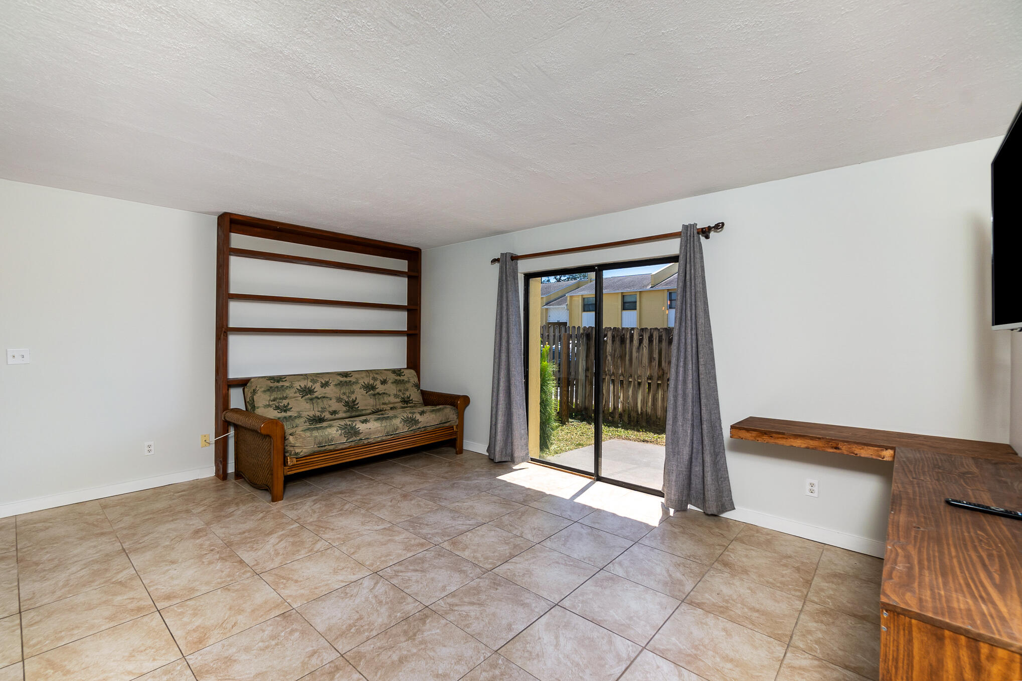 598 North Wickham Road, Unit 75 Melbourne, FL 32935 - Photo 3 of 21 a room with a bed and a large window