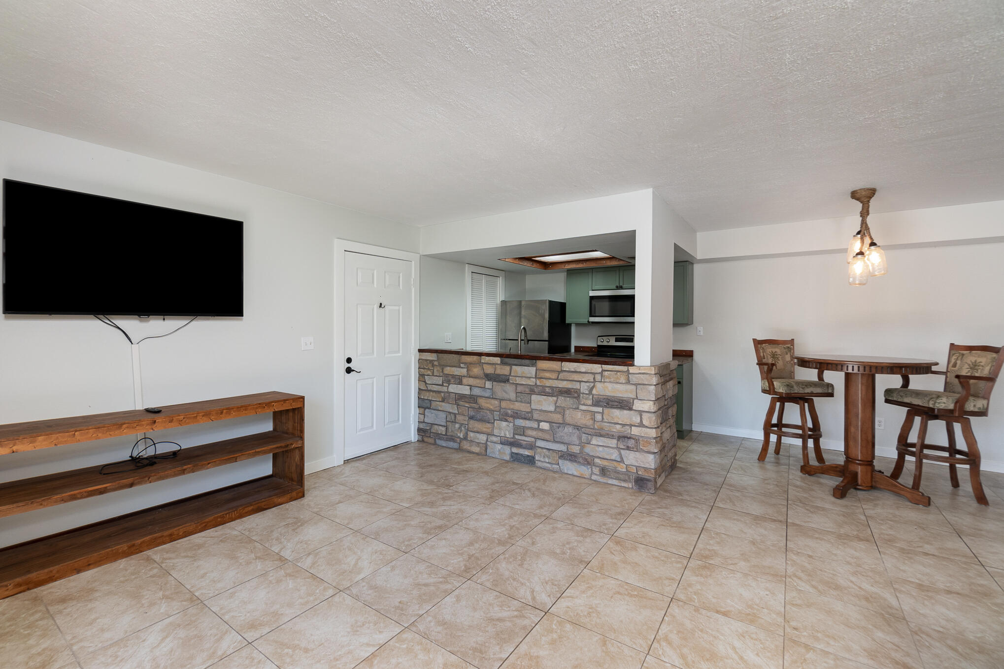598 North Wickham Road, Unit 75 Melbourne, FL 32935 - Photo 5 of 21 a living room with furniture and a flat screen tv
