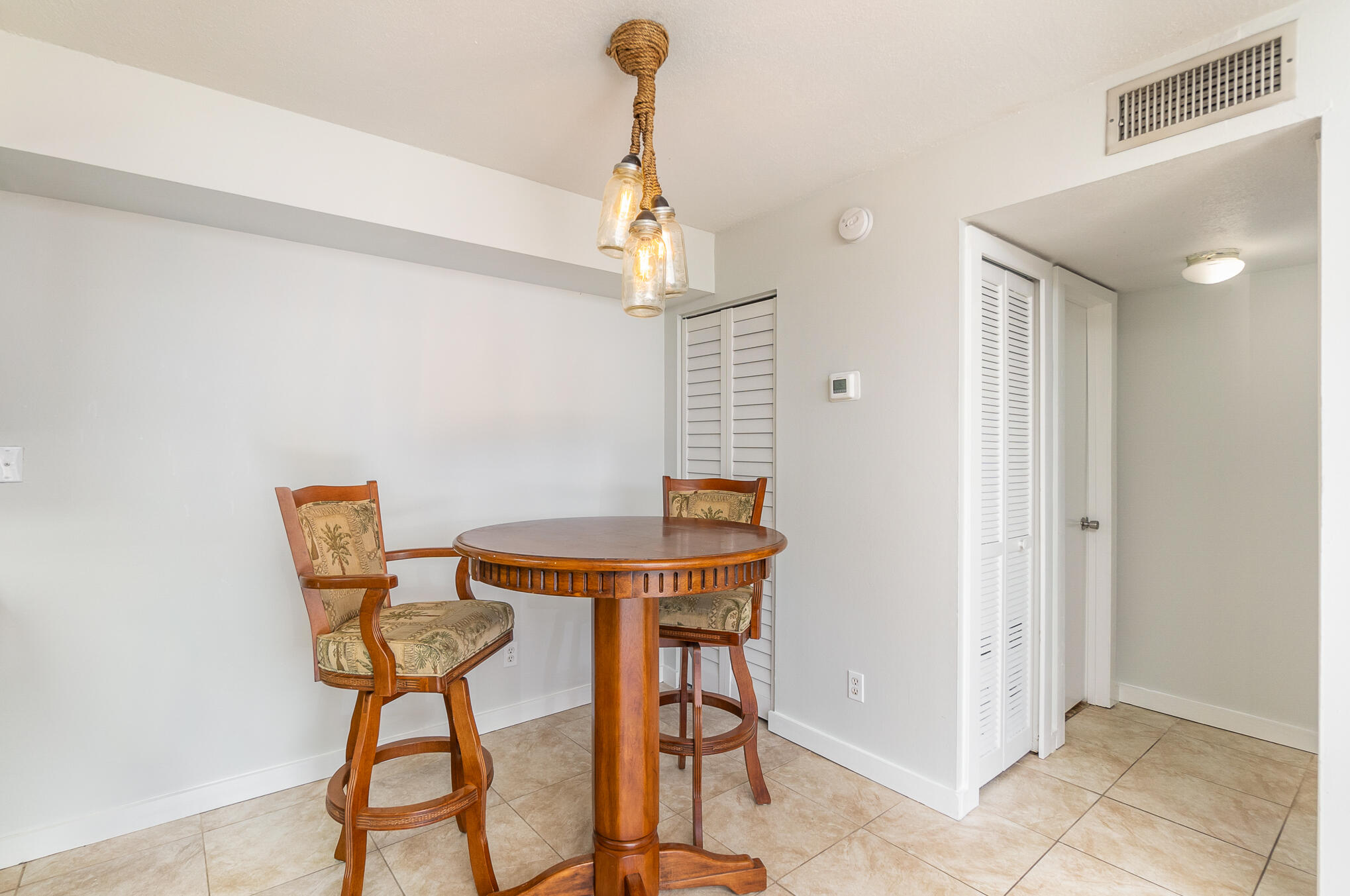 598 North Wickham Road, Unit 75 Melbourne, FL 32935 - Photo 7 of 21 a dining room with table chairs and wooden floor