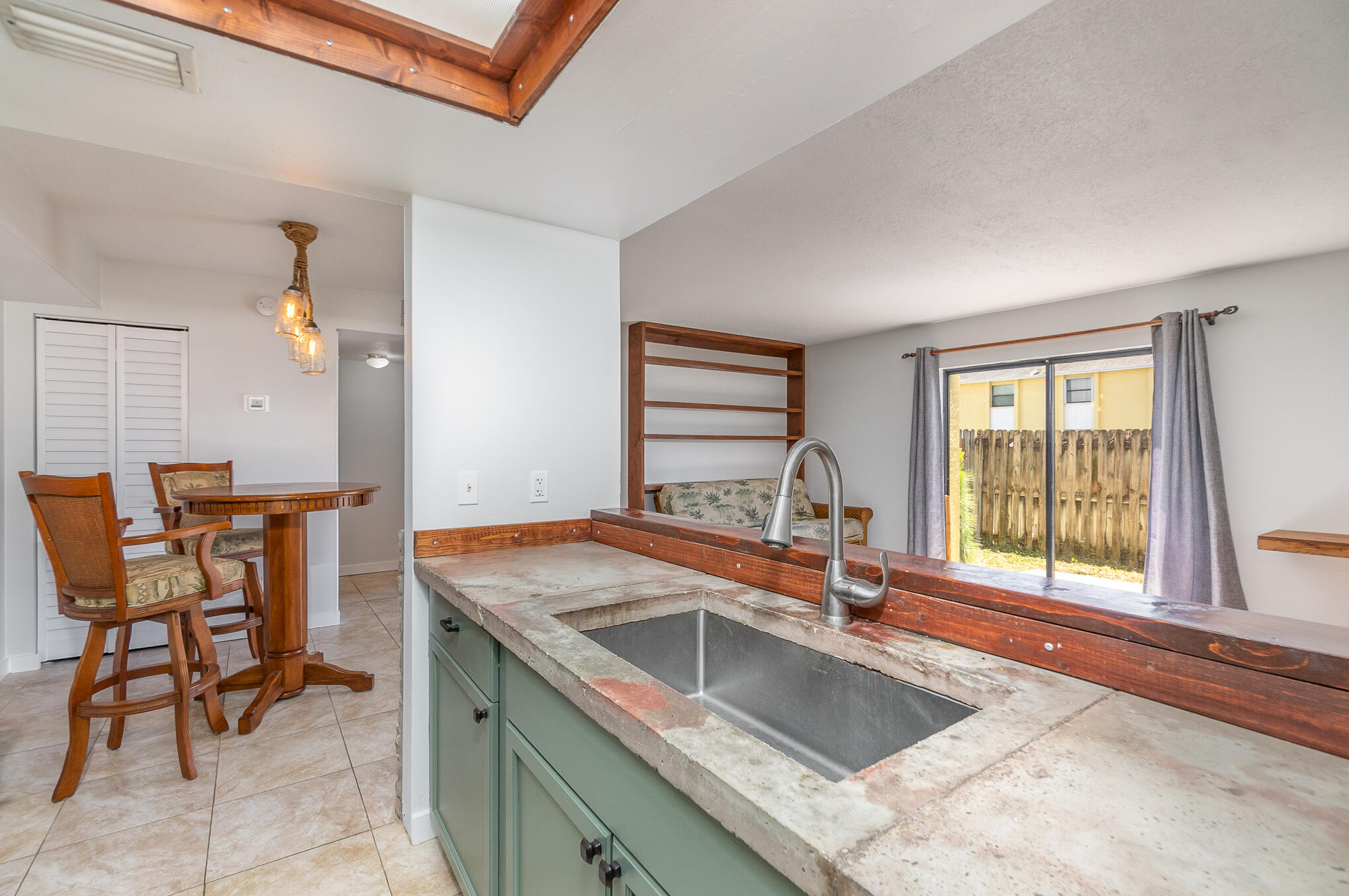 598 North Wickham Road, Unit 75 Melbourne, FL 32935 - Photo 9 of 21 a kitchen with a sink and chairs