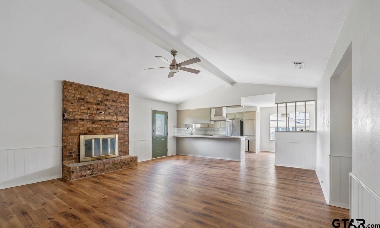 1602 Bowie Circle Tyler, TX 75701 - Photo 2 of 9 a view of empty room with wooden floor and window