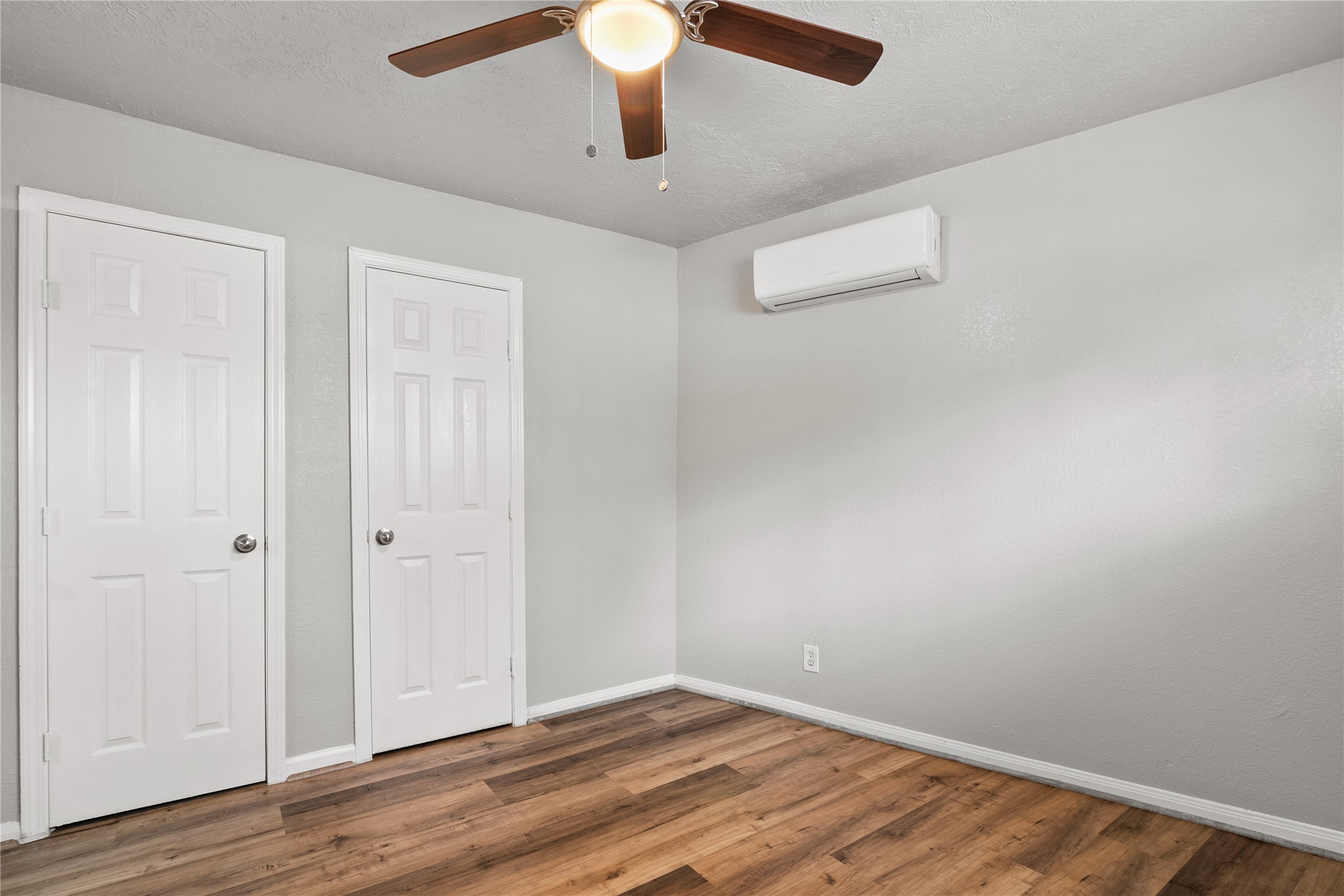 4811 Oakland Street, Unit 2 Houston, TX 77023 - Photo 15 of 19 an empty room with wooden floor chandelier fan and windows