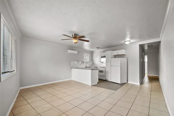 a kitchen with a refrigerator a sink and dishwasher with wooden floor