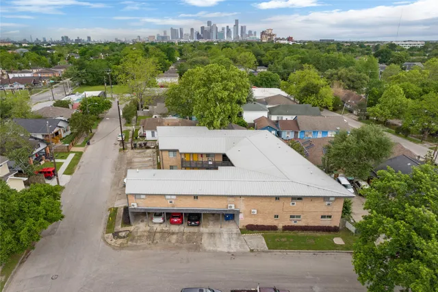 an aerial view of a house with a yard