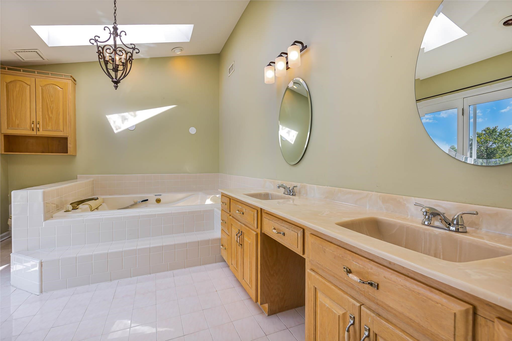 3591 Zacks Mill Road Angier, NC 27501 - Photo 19 of 44 a spacious bathroom with a double vanity sink mirror and bathtub