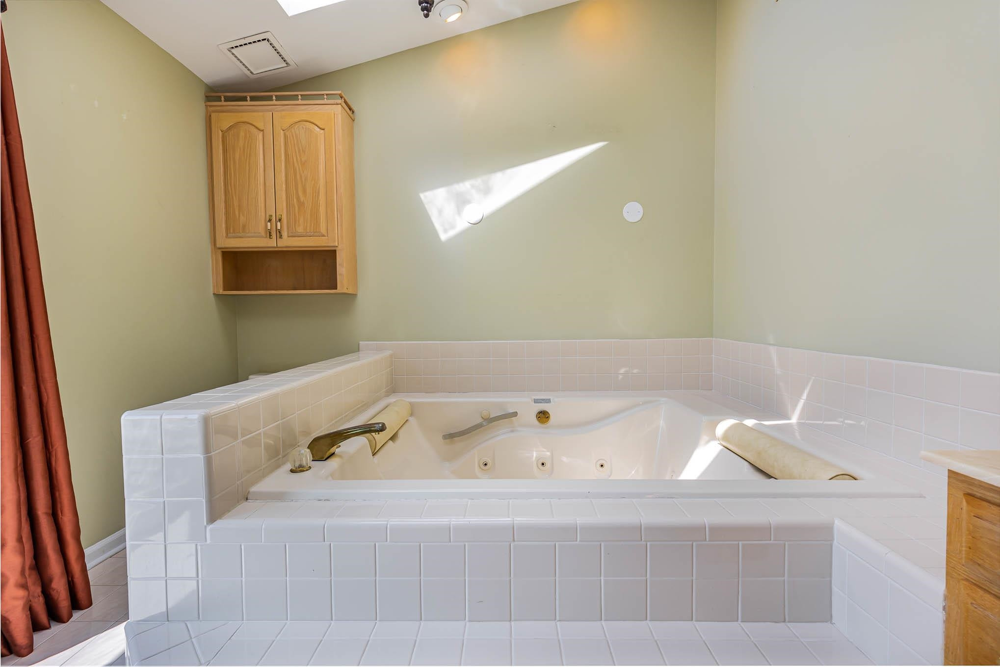 3591 Zacks Mill Road Angier, NC 27501 - Photo 20 of 44 a bathroom with a bathtub and a window