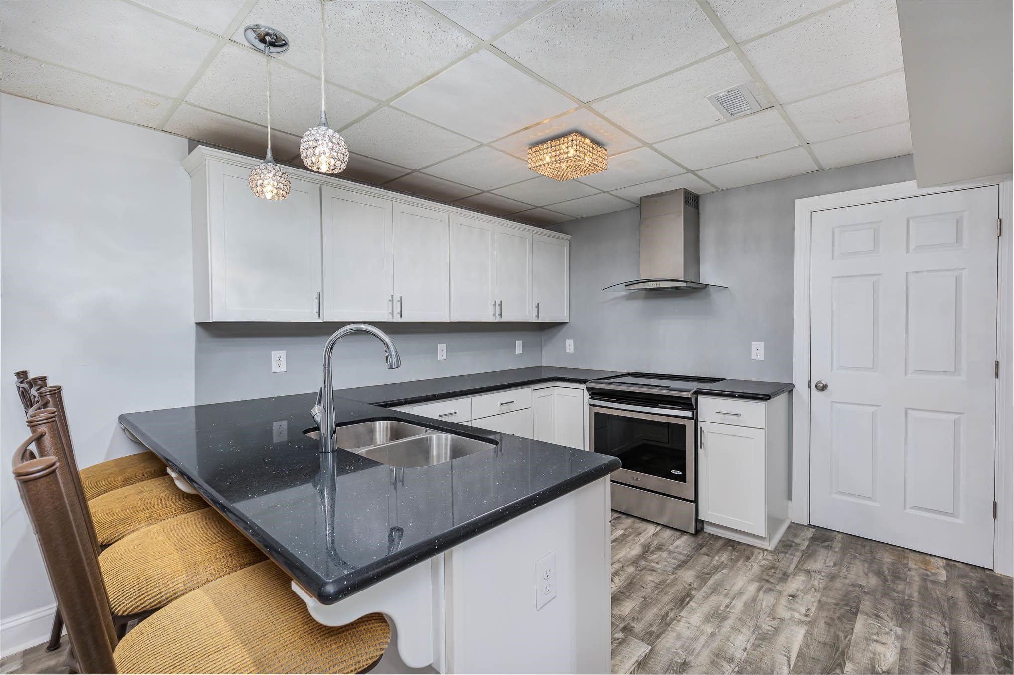 3591 Zacks Mill Road Angier, NC 27501 - Photo 24 of 44 a kitchen with stainless steel appliances granite countertop a sink a stove and a refrigerator