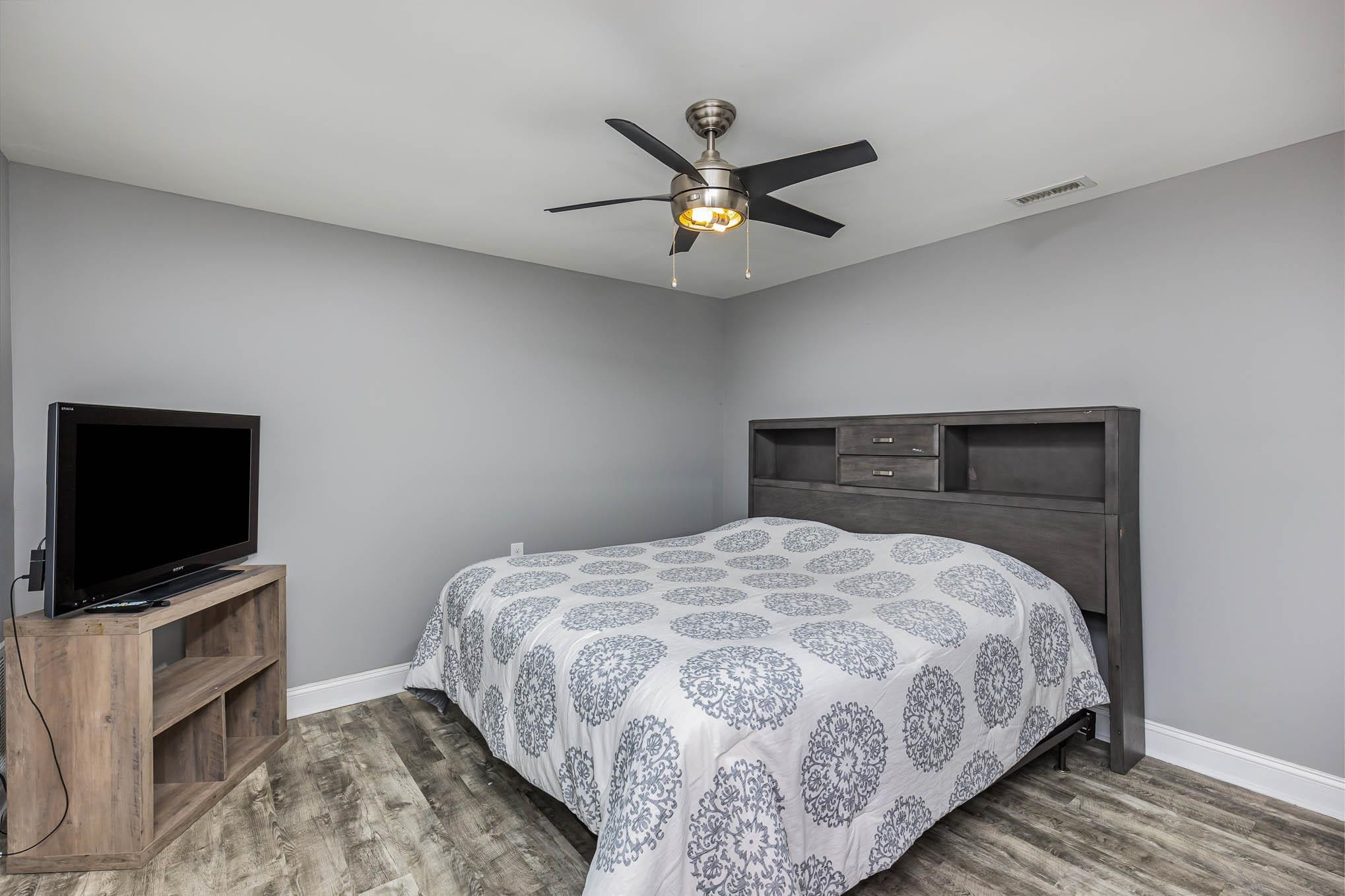 3591 Zacks Mill Road Angier, NC 27501 - Photo 26 of 44 a bedroom with a bed and a flat screen tv