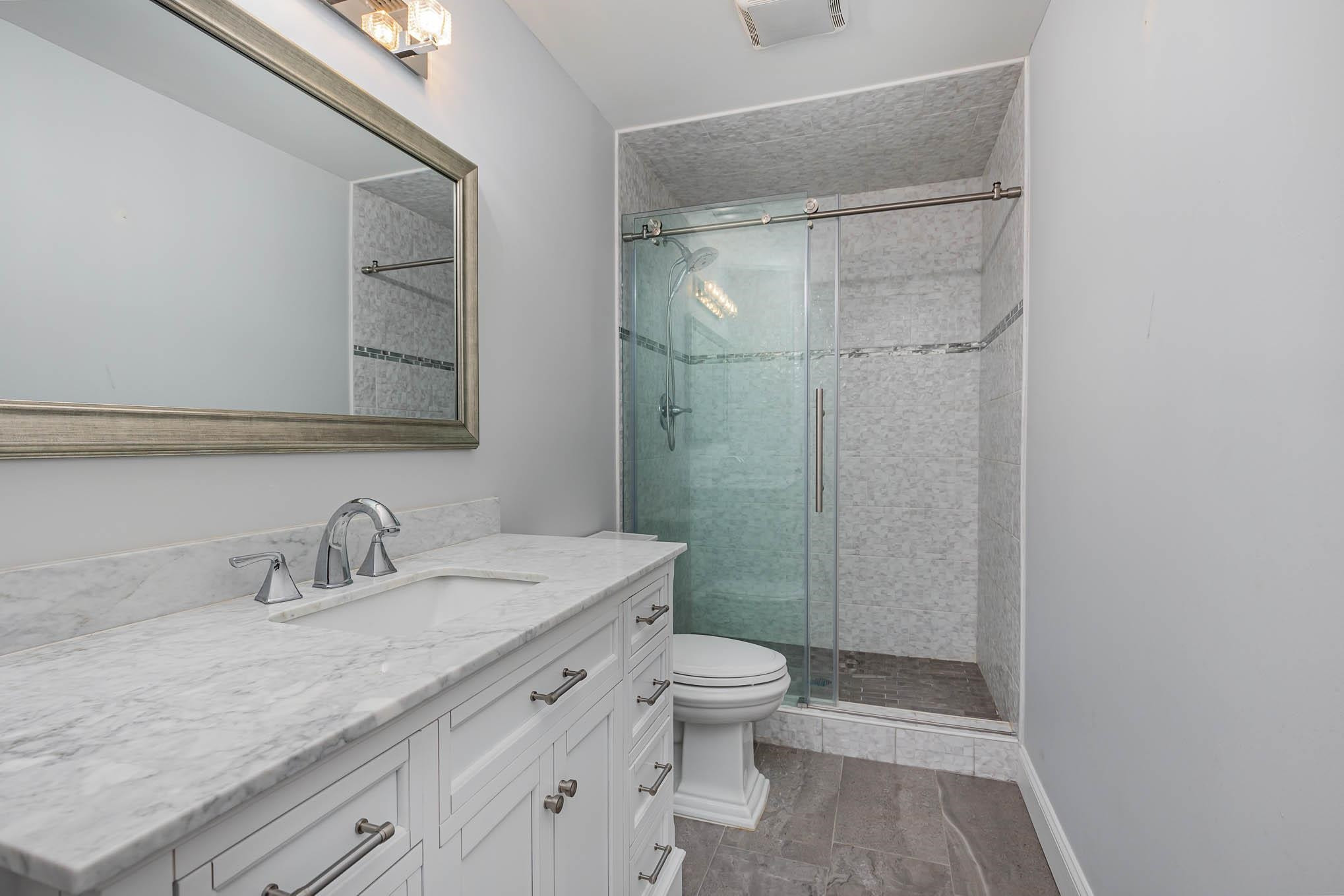 3591 Zacks Mill Road Angier, NC 27501 - Photo 27 of 44 a bathroom with a granite countertop sink toilet and shower
