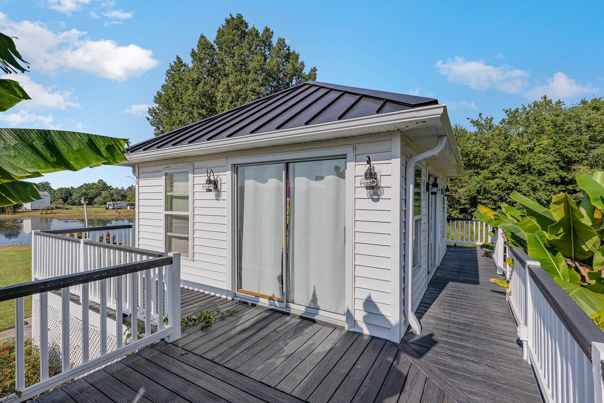 3591 Zacks Mill Road Angier, NC 27501 - Photo 32 of 44 a view of a house with a wooden deck