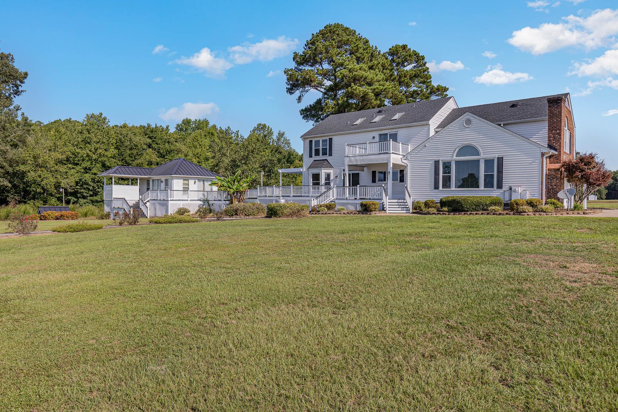 3591 Zacks Mill Road Angier, NC 27501 - Photo 34 of 44 a front view of a house with a garden and plants
