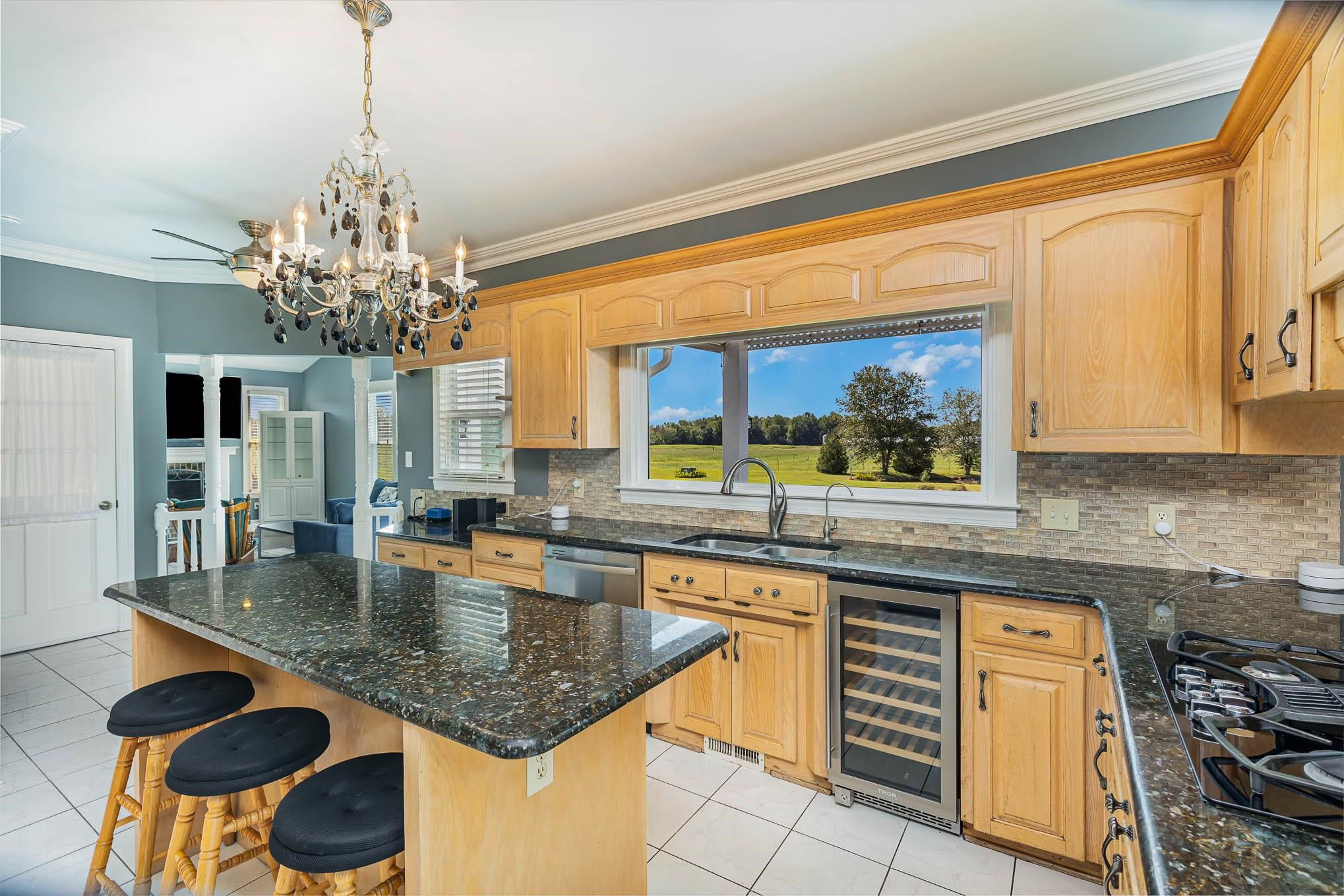 3591 Zacks Mill Road Angier, NC 27501 - Photo 5 of 44 a kitchen with stainless steel appliances granite countertop a sink dishwasher and cabinets with wooden floor